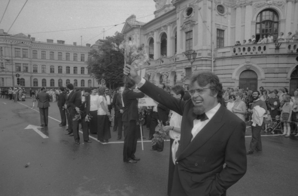 Spānijas  pilsētas Laspalmasas kamerkora dalībnieki sveic XIX Vispārējo latviešu Dziesmu un Deju svētku gājiena dalībniekus pie Latvijas Nacionālā teātra