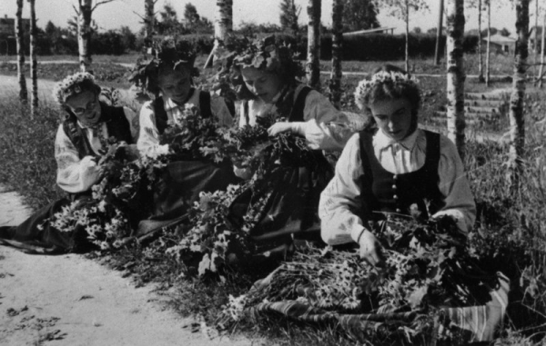 Dziesmu svētku dalībnieces vij vainagus