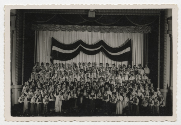 Kopkoris uz skatuves pēc koncerta. Diriģents Kaspars Svenne (priekšplānā)